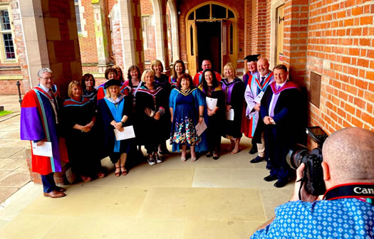 the photo shows St Mary's photographer Gerd taking a group picture of all of the St Mary's lecturers, bedecked in their ceremonial gowns and who were present at the graduation ceremony at Whitla Hall.