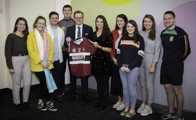 Vice-Chancellor of Queens University, Professor Ian Greer with members of the Students' Union Executive who presented him with an All-Ireland winning camogie jersey