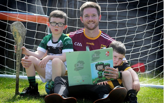 Michael Gerard Ó Dochartaigh, pictured with sonsIarla (5) and Connla (3), has created a series of personalised booklets called ‘Live, Learn, Love Gaelic Games’. Picture by Hugh Russell